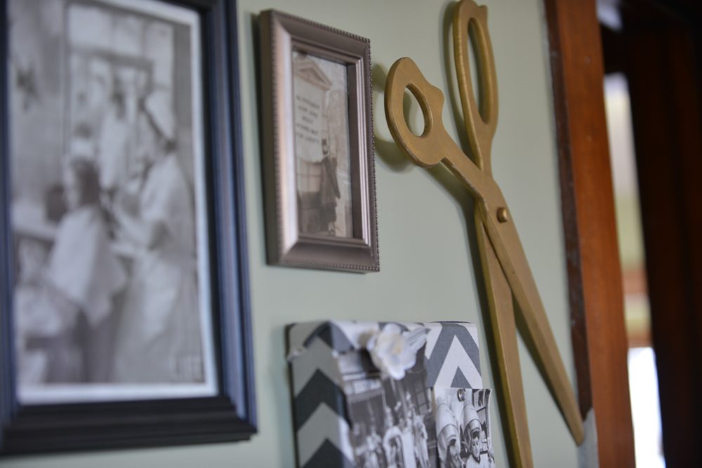 Vintage shears and black-and-white photos on the wall