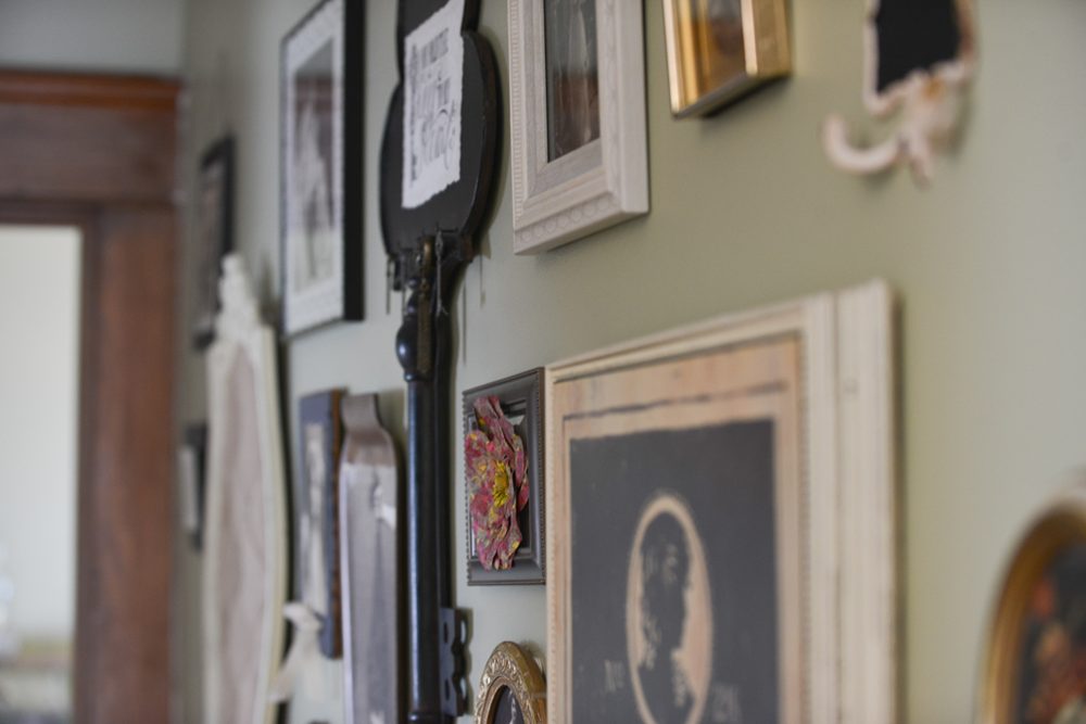 Framed pictures along the salon hallway